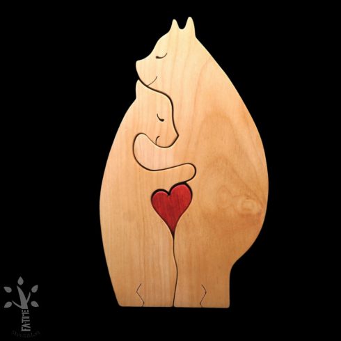 A pair of hugging polar bears made from light-colored wood, holding a red heart in their lap.