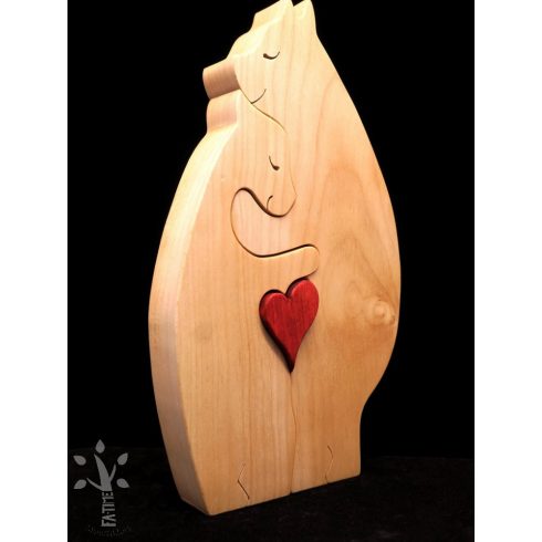 A pair of hugging polar bears made from light-colored wood, holding a red heart in their lap.