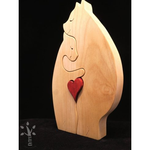 A pair of hugging polar bears made from light-colored wood, holding a red heart in their lap.